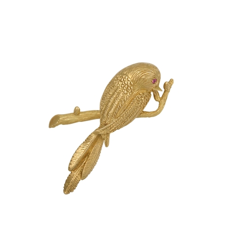 434 - A VINTAGE BOUCHERON NOVELTY BROOCH, modelled as a bird on a branch with ruby eye