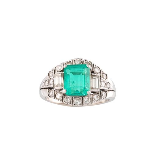 459 - AN EMERALD AND DIAMOND CLUSTER RING, the octagonal emerald to a brilliant and baguette diamond surro... 