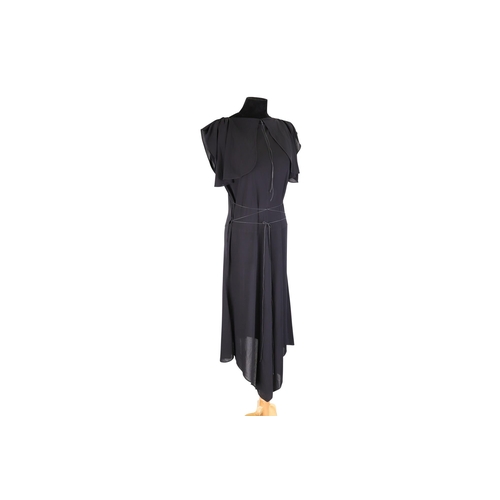 565 - A LADY'S ALAIA PARIS BLACK EVENING DRESS, the viscose fabric with split flutter sleeves and tie deta... 