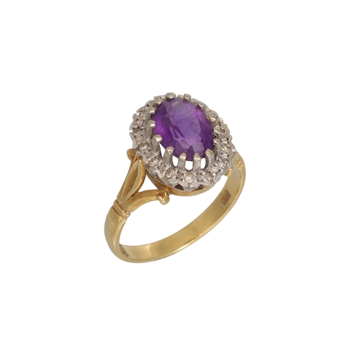 62 - AN AMETHYST AND DIAMOND CLUSTER RING, mounted in 18ct gold, size N