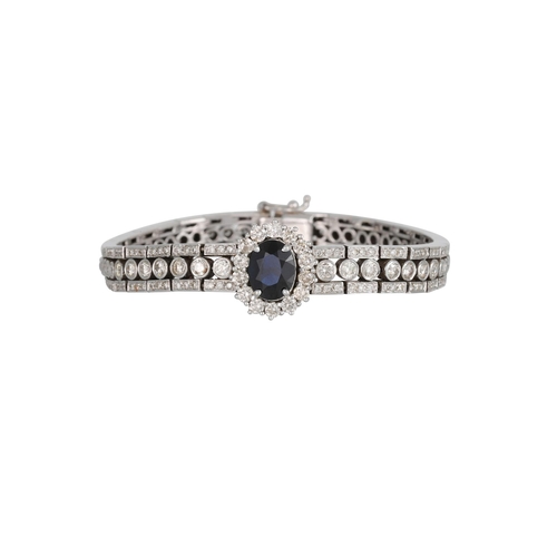 96 - A DIAMOND AND SAPPHIRE BRACELET, the oval sapphire and diamond cluster set to the centre, on brillia... 