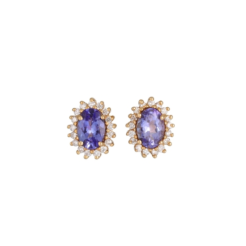 97 - A PAIR OF DIAMOND AND TANZANITE CLUSTER EARRINGS, mounted in yellow gold