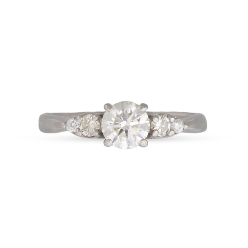 307 - A DIAMOND SOLITAIRE RING, the brilliant cut diamond to diamond shoulders, mounted in platinum. Estim... 