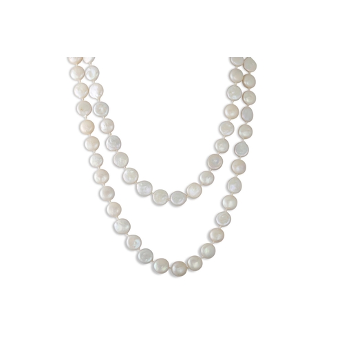 39 - A LONG STRANDED PEARL NECKLACE, silver clasp