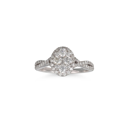 46 - A DIAMOND CLUSTER RING, of oval form, set with brilliant cut diamonds, to diamond shoulders, mounted... 