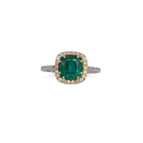 138 - AN EMERALD AND DIAMOND CLUSTER RING, the cushion cut emerald to diamond surround and shoulders, moun... 