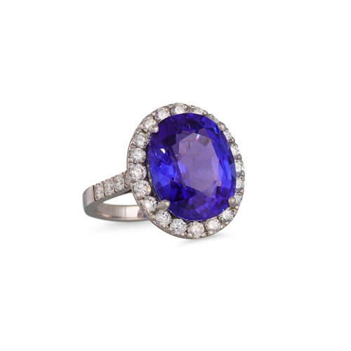 272 - A TANZANITE AND DIAMOND RING, the oval tanzanite to brilliant cut diamond surround and diamond shoul... 