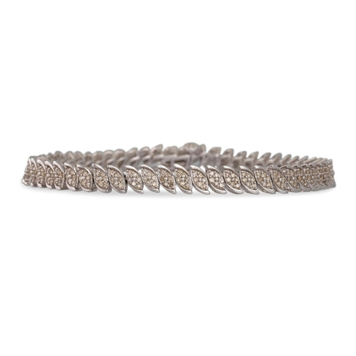 36 - A DIAMOND BRACELET, each shaped link set with a diamond cluster, mounted in white gold. Estimated: w... 