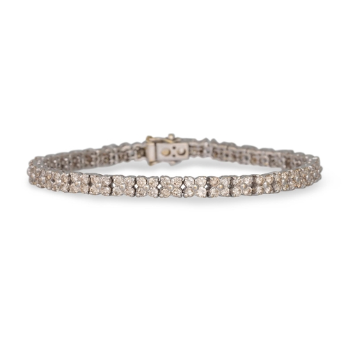 45 - A DIAMOND LINE BRACELET, comprising clusters, mounted in white gold. Estimated: weight of diamonds: ... 