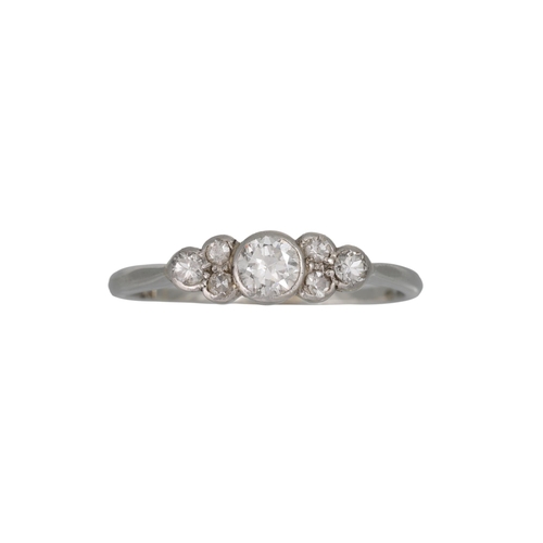 64 - A DIAMOND RING, the centre circular diamond to trio diamond shoulders, mounted in platinum. Estimate... 