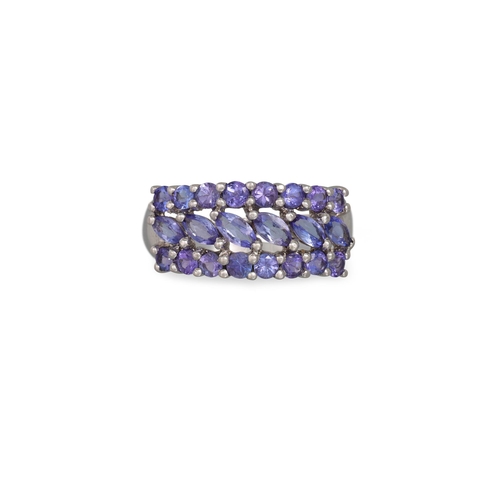 99 - A THREE ROWED TANZANITE RING, mounted in 9ct gold, size P