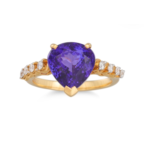 11 - A TANZANITE AND DIAMOND RING, the pear shaped tanzanite to diamond shoulders, mounted in 18ct yellow... 