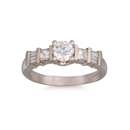 255 - A DIAMOND SOLITAIRE RING, the brilliant cut diamond to princess and baguette shoulders, mounted in 1... 