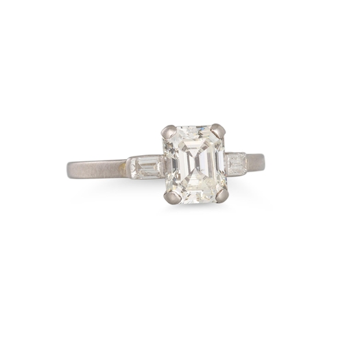 280 - A DIAMOND SOLITAIRE RING, the emerald cut diamond to baguette diamond shoulders, mounted in platinum... 