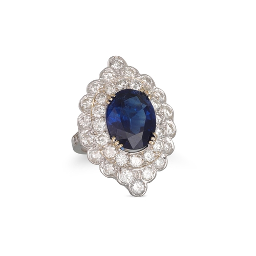 353 - A SAPPHIRE AND DIAMOND CLUSTER RING, the oval sapphire to a two rowed brilliant cut diamond surround... 