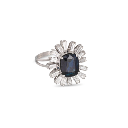 356 - A SAPPHIRE AND DIAMOND CLUSTER RING, the cushion cut sapphire to a tapered baguette diamond surround... 