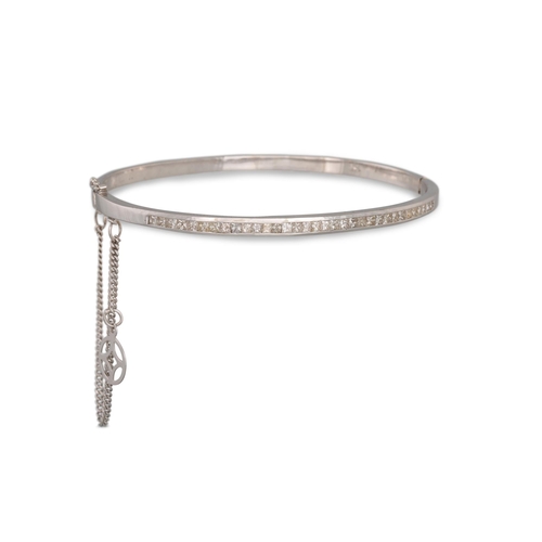 360 - A DIAMOND SET BANGLE, channel set with princess cut diamonds, mounted in 18ct white gold. Estimated:... 