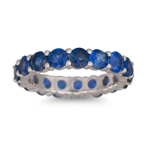 251 - A SAPPHIRE ETERNITY RING, the circular stones mounted in 18ct white gold. Estimated: weight of sapph... 