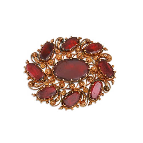 3 - A 21CT CONTINENTAL WIRE WORK OVAL BROOCH, set with garnet, 10.4 g. (pin not gold)