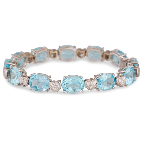 303 - A BLUE TOPAZ AND DIAMOND SET BRACELET, the oval stones to heart shaped diamond spacers, mounted in 1... 