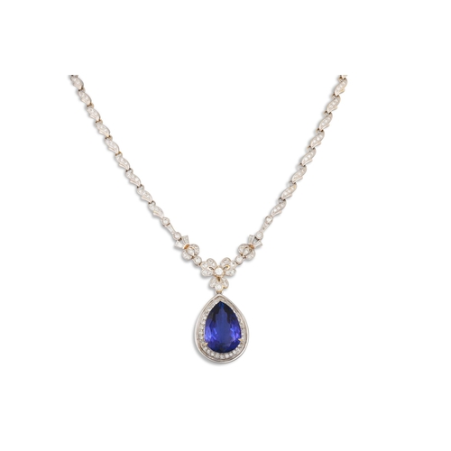 307 - A TANZANITE AND DIAMOND NECKLACE, the diamond set chain suspending a pear shaped diamond and tanzani... 