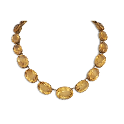 308 - A CITRINE NECKLACE, comprising graduated oval stones in yellow gold