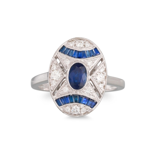 35 - A DIAMOND AND SAPPHIRE CLUSTER RING, the oval sapphire to diamond and sapphire surround, mounted in ... 