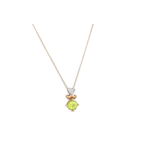 65 - A PERIDOT AND DIAMOND PENDANT, heart shaped, in 9ct gold on a chain