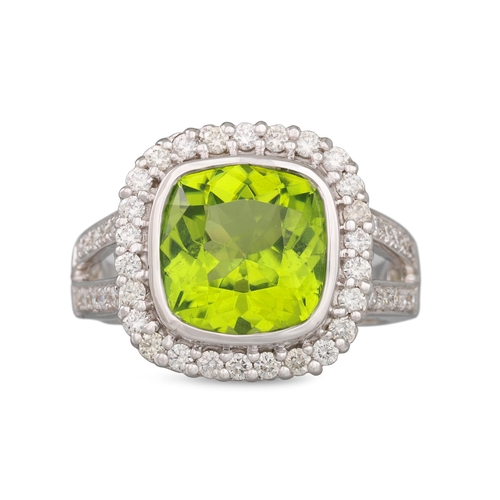 36 - A PERIDOT AND DIAMOND CLUSTER RING, mounted in 14ct gold, size L