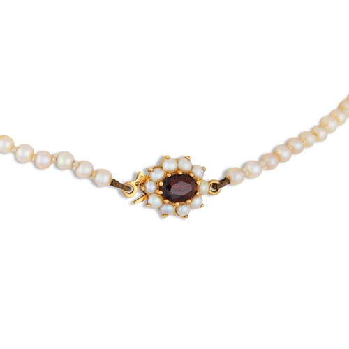 86 - A CULTURED PEARL NECKLACE, to a 9ct gold and garnet set clasp