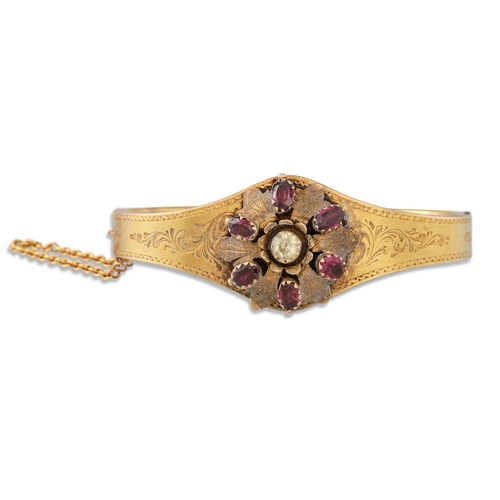 AN ANTIQUE GEM SET BANGLE, mounted in 18ct yellow gold, floral motif to ...