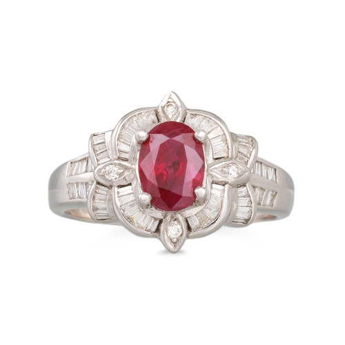 345 - A RUBY AND DIAMOND RING, the oval ruby to baguette and brilliant cut diamond surround, mounted in 18... 