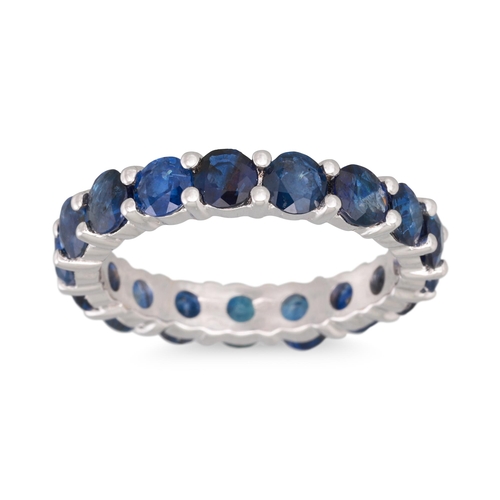 384 - A SAPPHIRE ETERNITY RING, circular stones mounted in 18ct white gold. Estimated: weight of sapphires... 