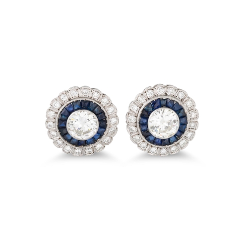 217 - A PAIR OF SAPPHIRE AND DIAMOND TARGET CLUSTER EARRINGS, the central brilliant cut diamonds to sapphi... 