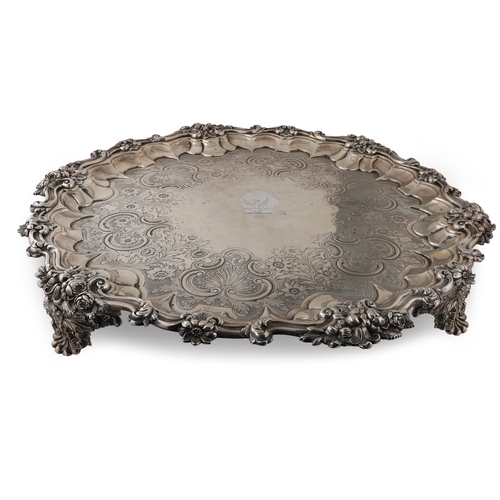 393 - AN IMPRESSIVE WILLIAM IV CIRCULAR SILVER SALVER, with chased & engraved floral decoration, raised ov... 