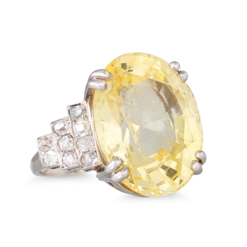 290 - AN EARLY 20TH CENTURY YELLOW SAPPHIRE AND DIAMOND RING, the oval sapphire to stepped diamond shoulde... 