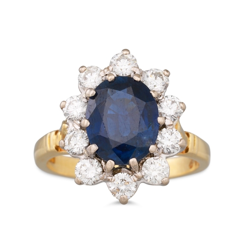 101 - A SAPPHIRE AND DIAMOND CLUSTER RING, the oval sapphire to a brilliant cut diamond surround, mounted ... 