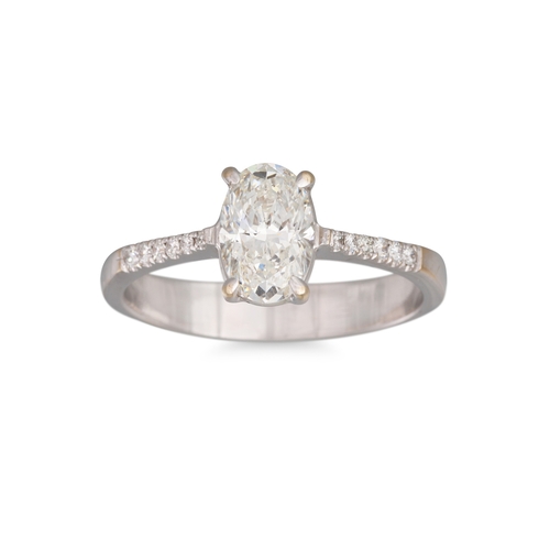 145 - A DIAMOND SOLITAIRE RING, the oval brilliant cut diamond mounted in 18ct white gold to diamond shoul... 