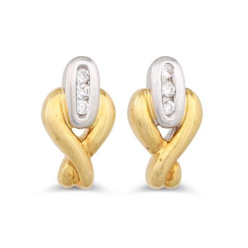 18 - A PAIR OF DIAMOND SET EARRINGS, mounted in 18ct white and yellow gold, of cross over design, mounted... 