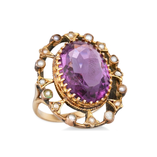 21 - AN ANTIQUE GOLD AMETHYST AND PEARL RING, the oval amethyst to seed pearl surround of openwork form, ... 