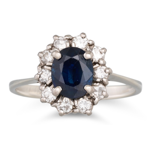 91 - A SAPPHIRE AND DIAMOND CLUSTER DRESS RING, mounted in 18ct white gold, size M - N