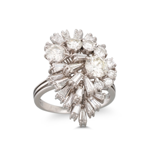 57 - A VINTAGE DIAMOND CLUSTER RING, of spray design, set with tapered baguette and brilliant cut diamond... 