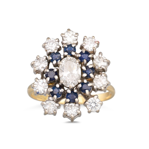 96 - A SAPPHIRE AND DIAMOND CLUSTER RING, the central oval cut diamond to sapphire surround to outer diam... 