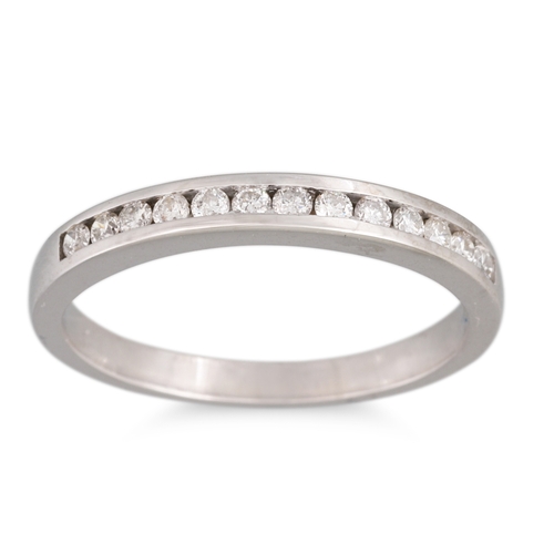 160 - A DIAMOND CHANNEL SET HALF ETERNITY RING, mounted in 18ct white gold, size M