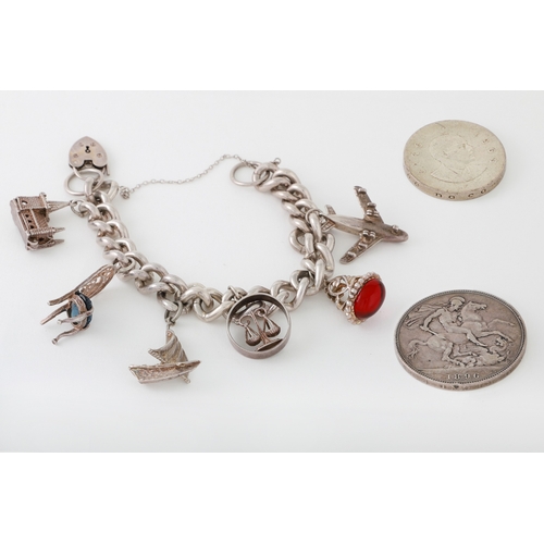 3 - A SILVER CHARM BRACELET, with various charms attached, gross weight 84.4 g. together with a Padraig ... 