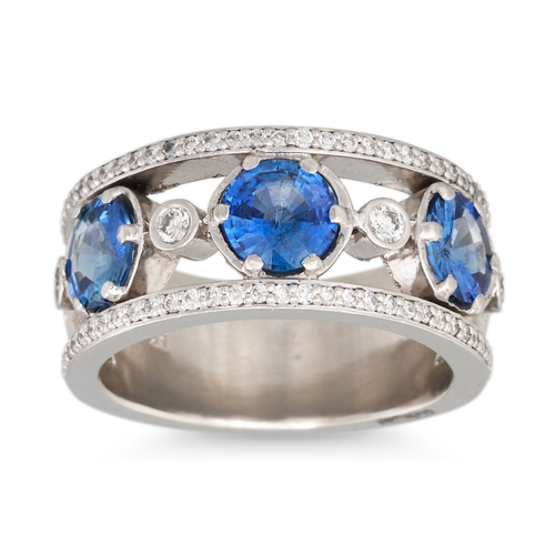 337 - A SAPPHIRE AND DIAMOND BAND RING, the circular sapphires within diamond border, mounted in platinum.... 