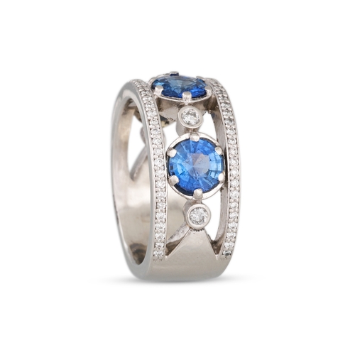 337 - A SAPPHIRE AND DIAMOND BAND RING, the circular sapphires within diamond border, mounted in platinum.... 