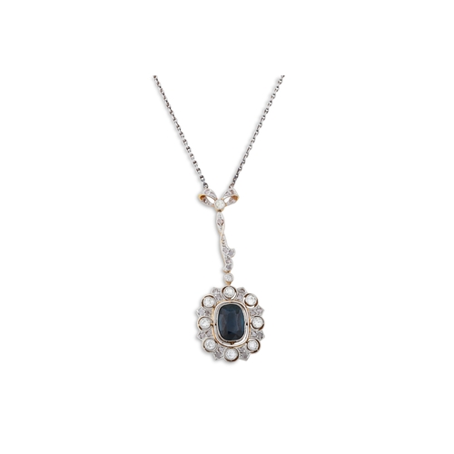 114 - AN EDWARDIAN SAPPHIRE AND DIAMOND CLUSTER PENDANT, the cluster suspended from a diamond set bow to a... 