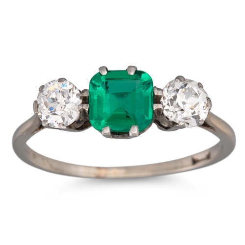 155 - A COLOMBIAN EMERALD AND DIAMOND THREE STONE RING, flanked by old cut diamonds, mounted in white gold... 