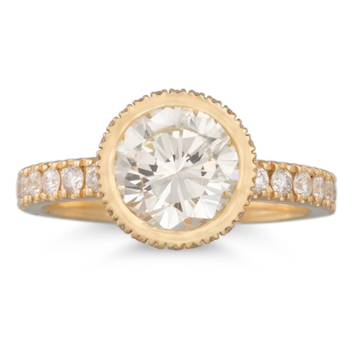 219 - A DIAMOND SOLITAIRE RING, the brilliant cut diamond bezel, diamond set shoulders, 18ct yellow gold m... 